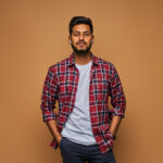 stylish handsome indian man in tshirt on pastel background